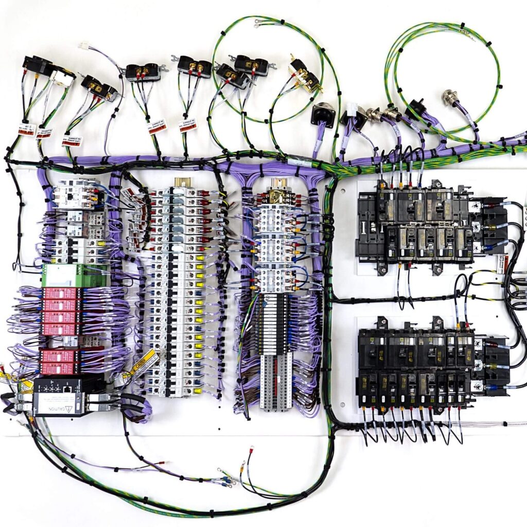 Electromechanical Engineer uses harness peg board to create cable and wire assembly