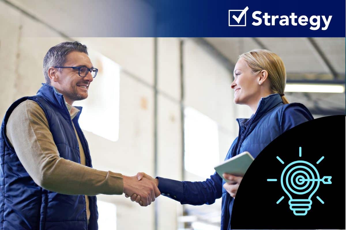 Federal Elec Blog-10 Graphic-04 Two manufacturing professionals shaking hands on a factory floor, symbolizing strategic supplier partnerships and long-term sourcing stability.