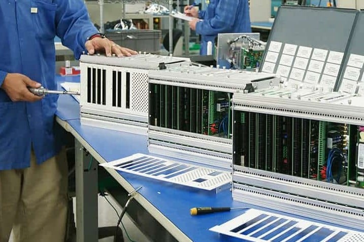 Federal-Electronics-Industrial-1 Federal Electronics technicians assembling and testing complex integrated electronic systems.